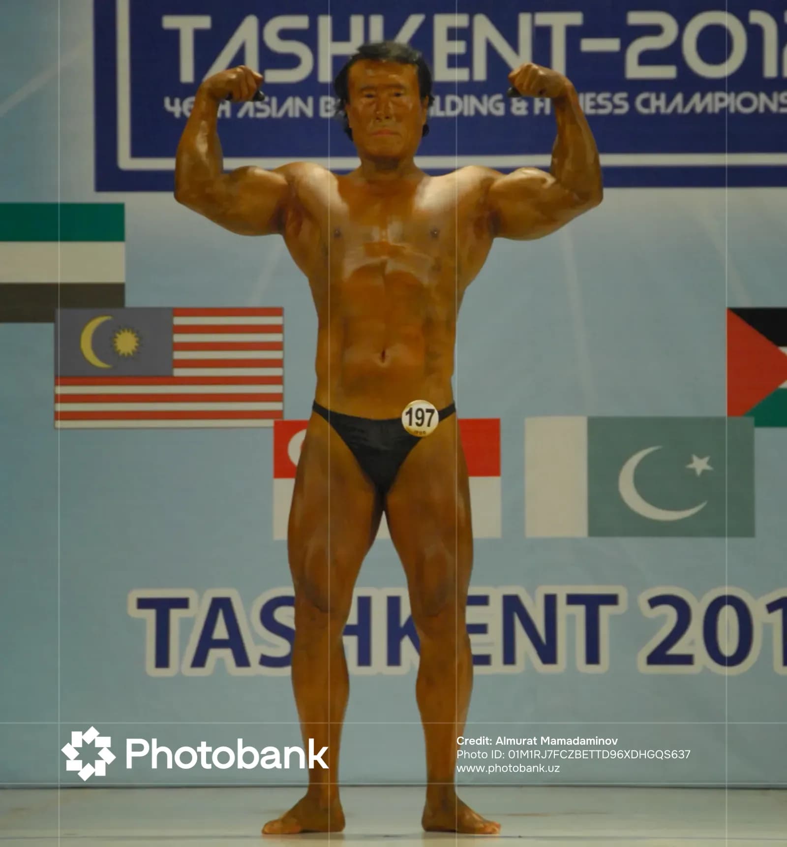 Athlete poses on stage during competition
