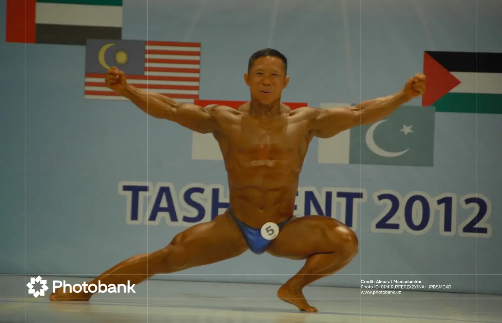 Bodybuilder performs a pose on stage during a competition