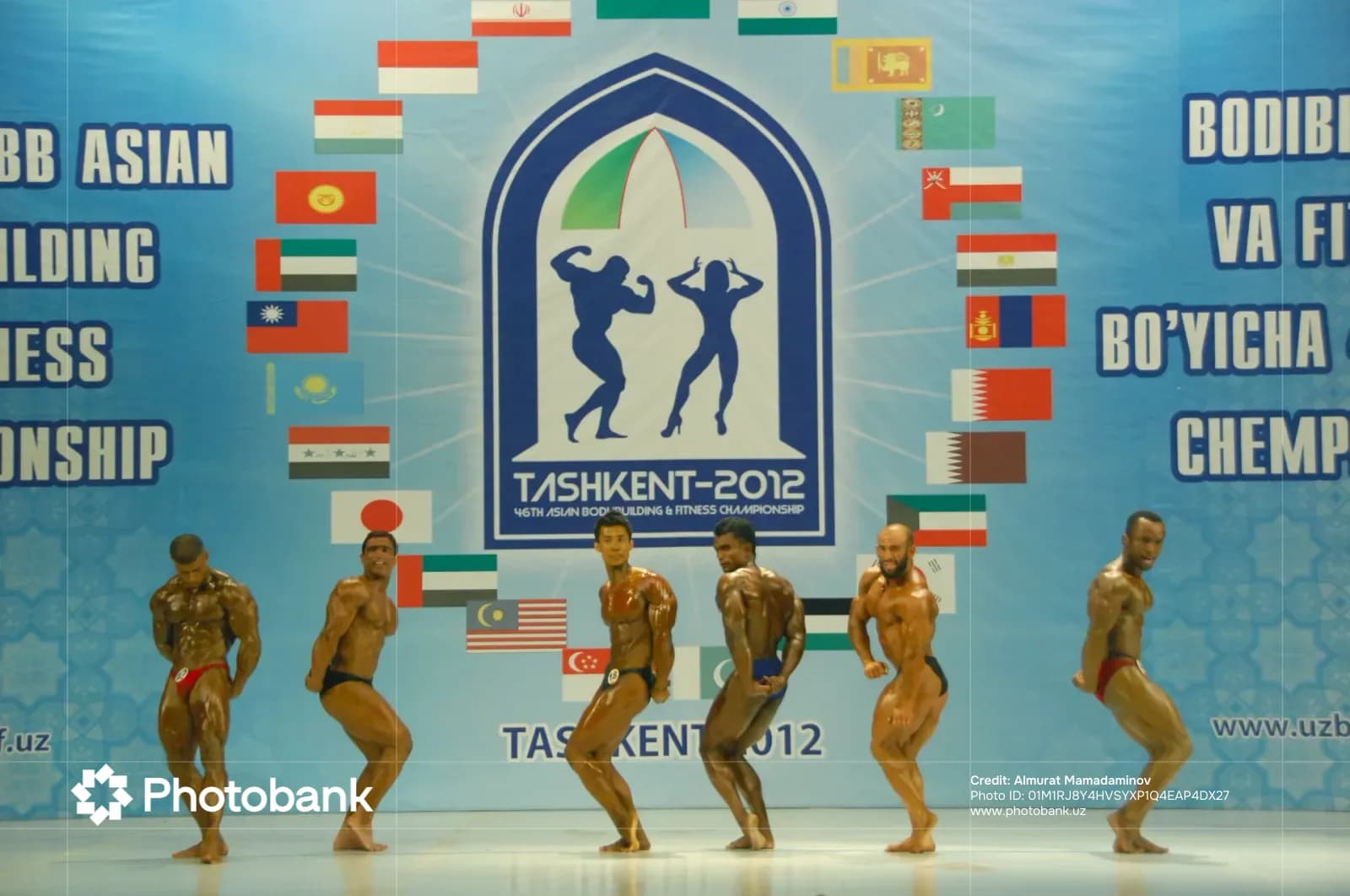Bodybuilders posing on stage during a competition