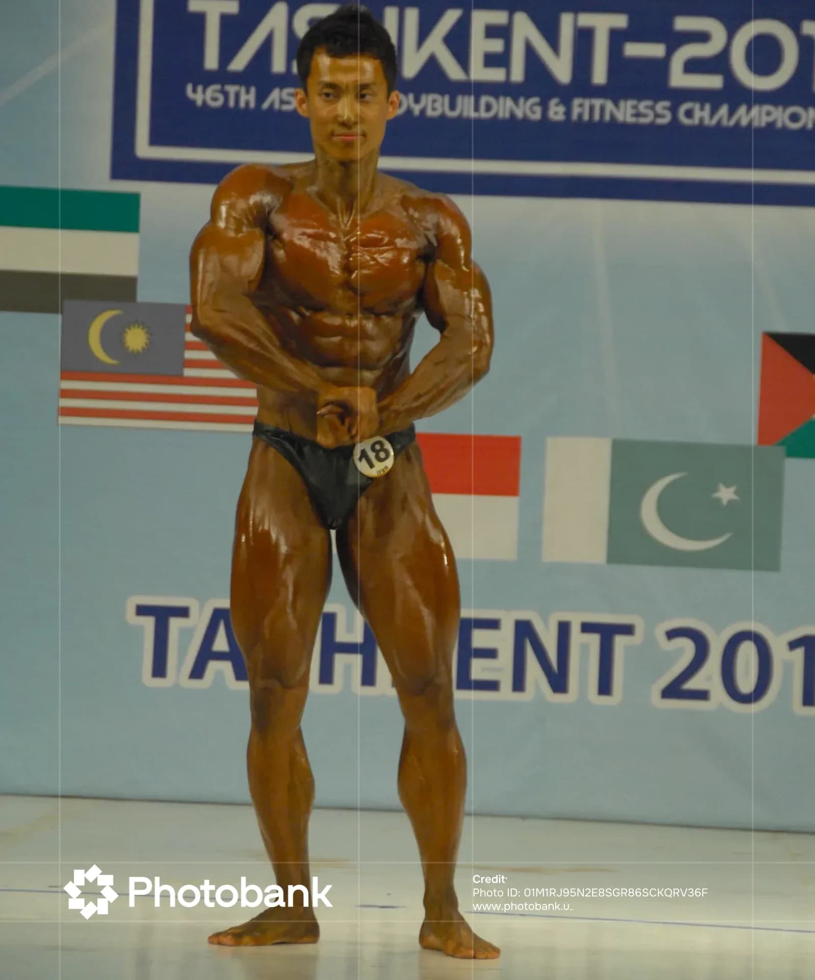 Bodybuilder posing during a sports competition