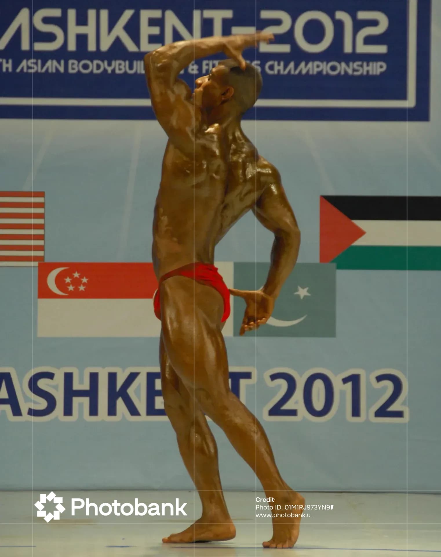 Athlete posing on stage during a bodybuilding competition