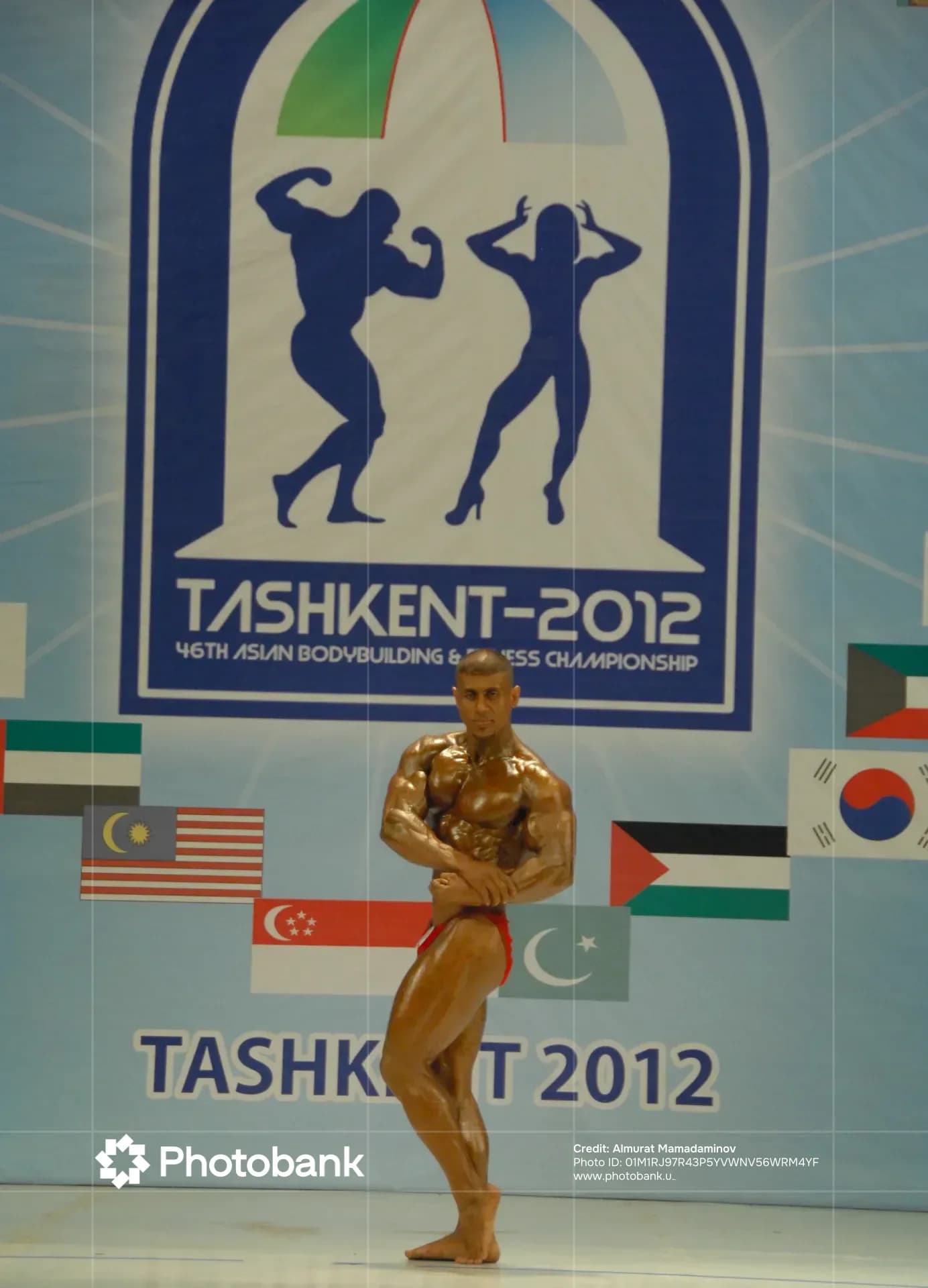 Bodybuilder poses on stage at a championship event