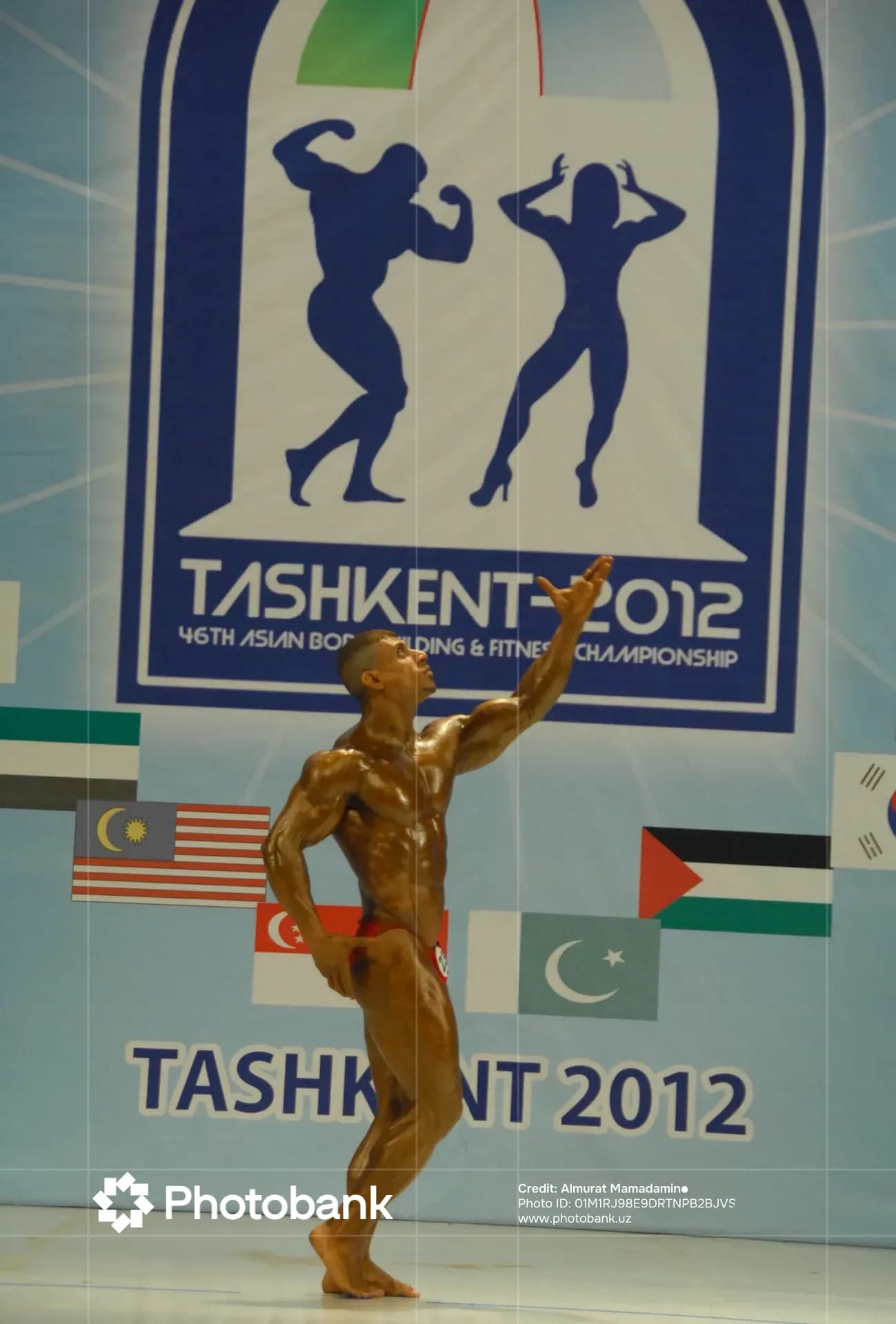 Bodybuilder poses on stage during competition