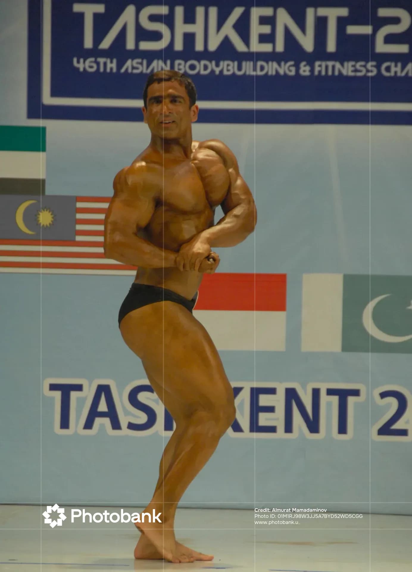 Athlete posing on stage during a bodybuilding competition