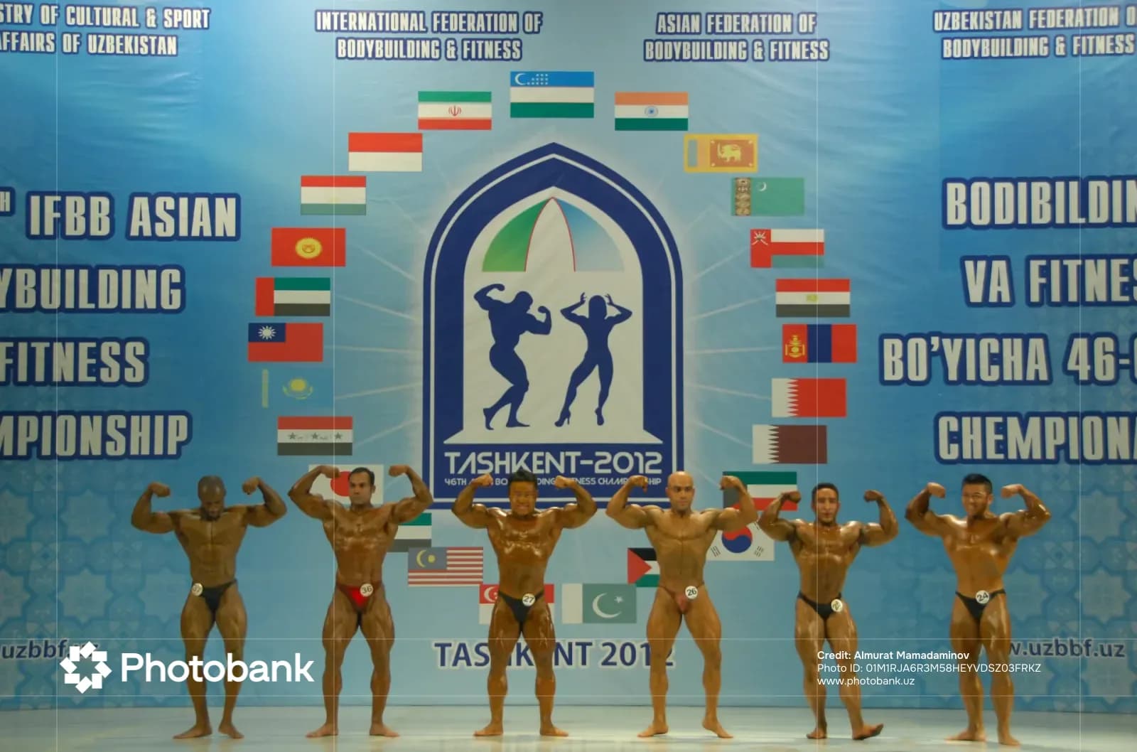 Bodybuilders posing on stage during a competition
