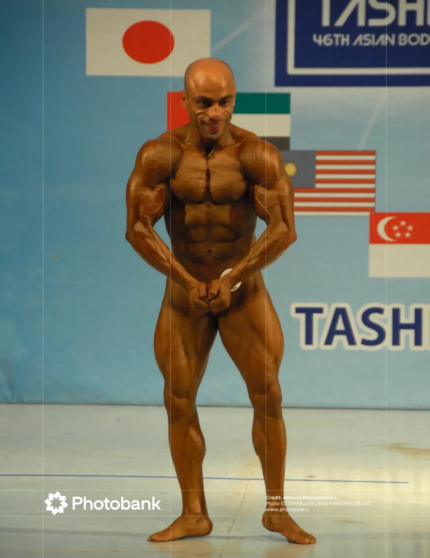 Athlete posing on stage during a competition