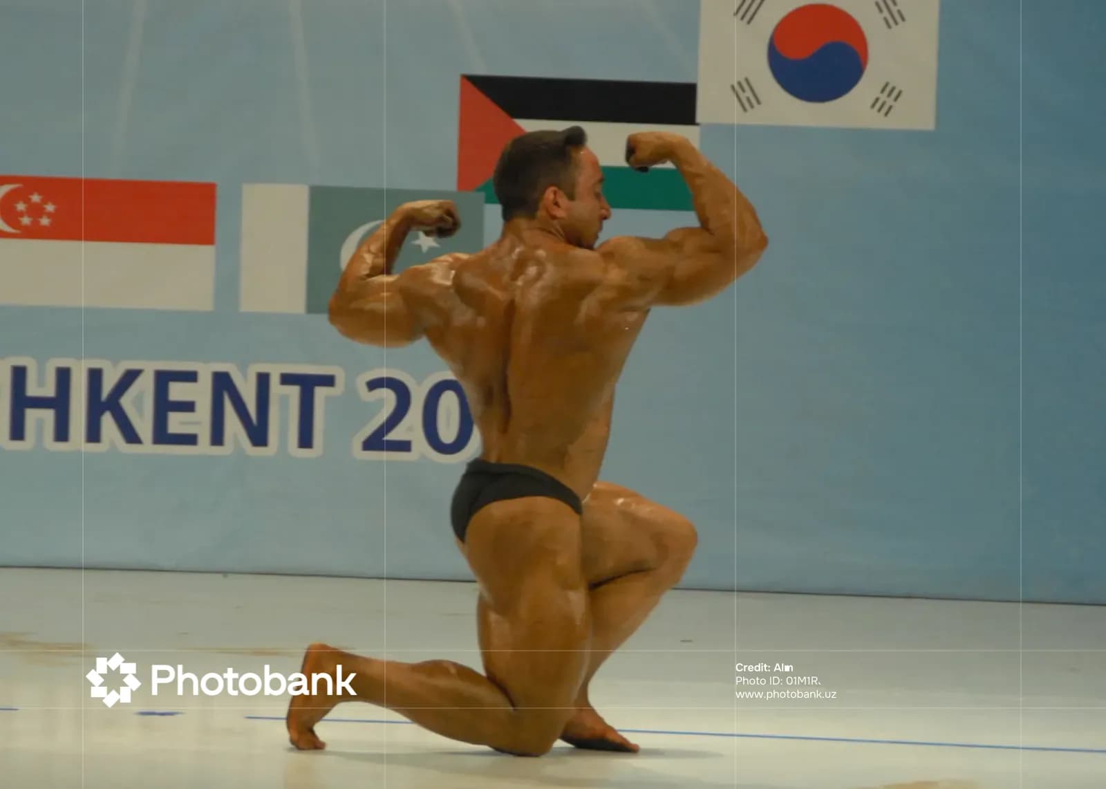 Athlete poses on stage during a sports competition