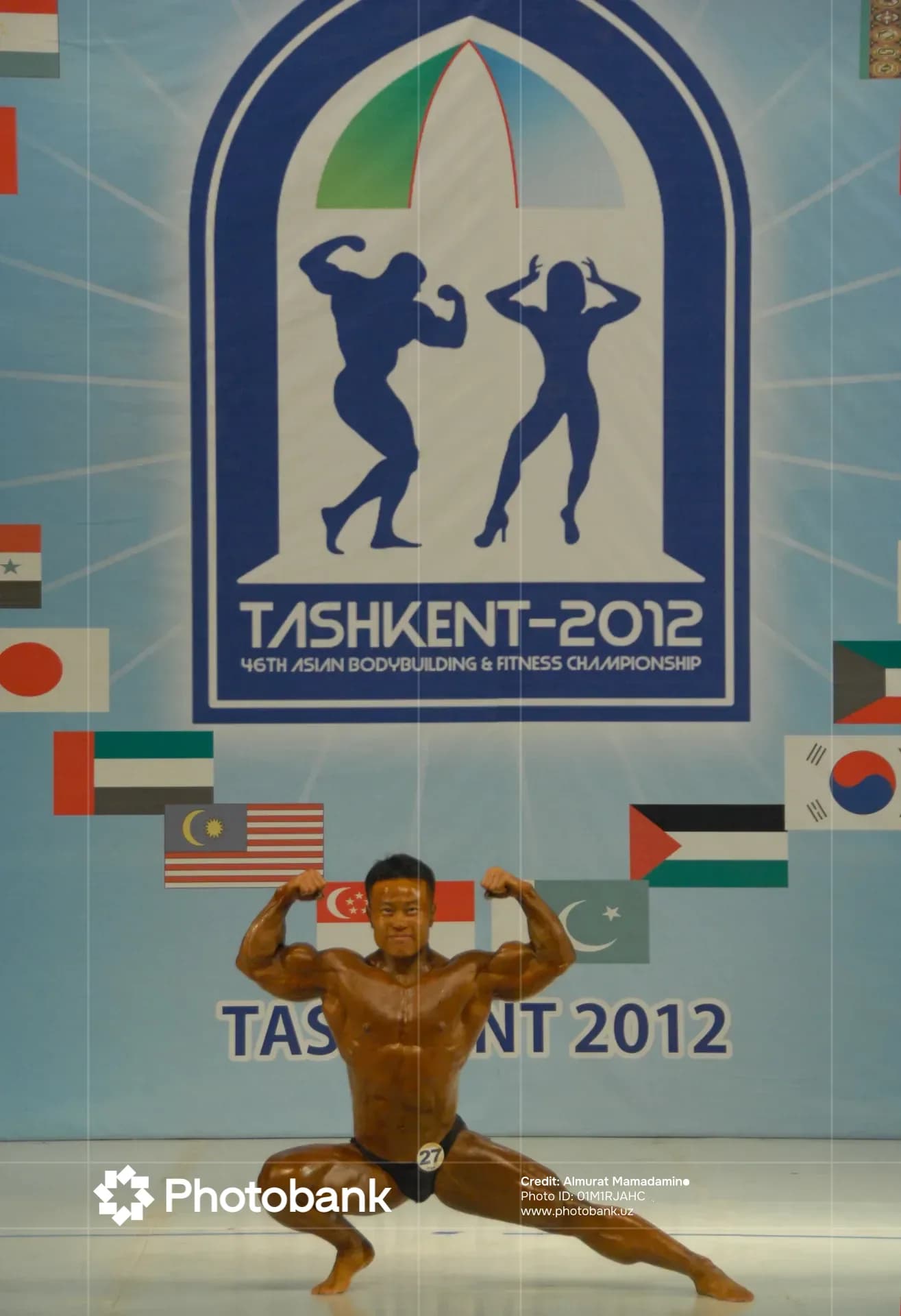 Athlete poses on stage during a bodybuilding event