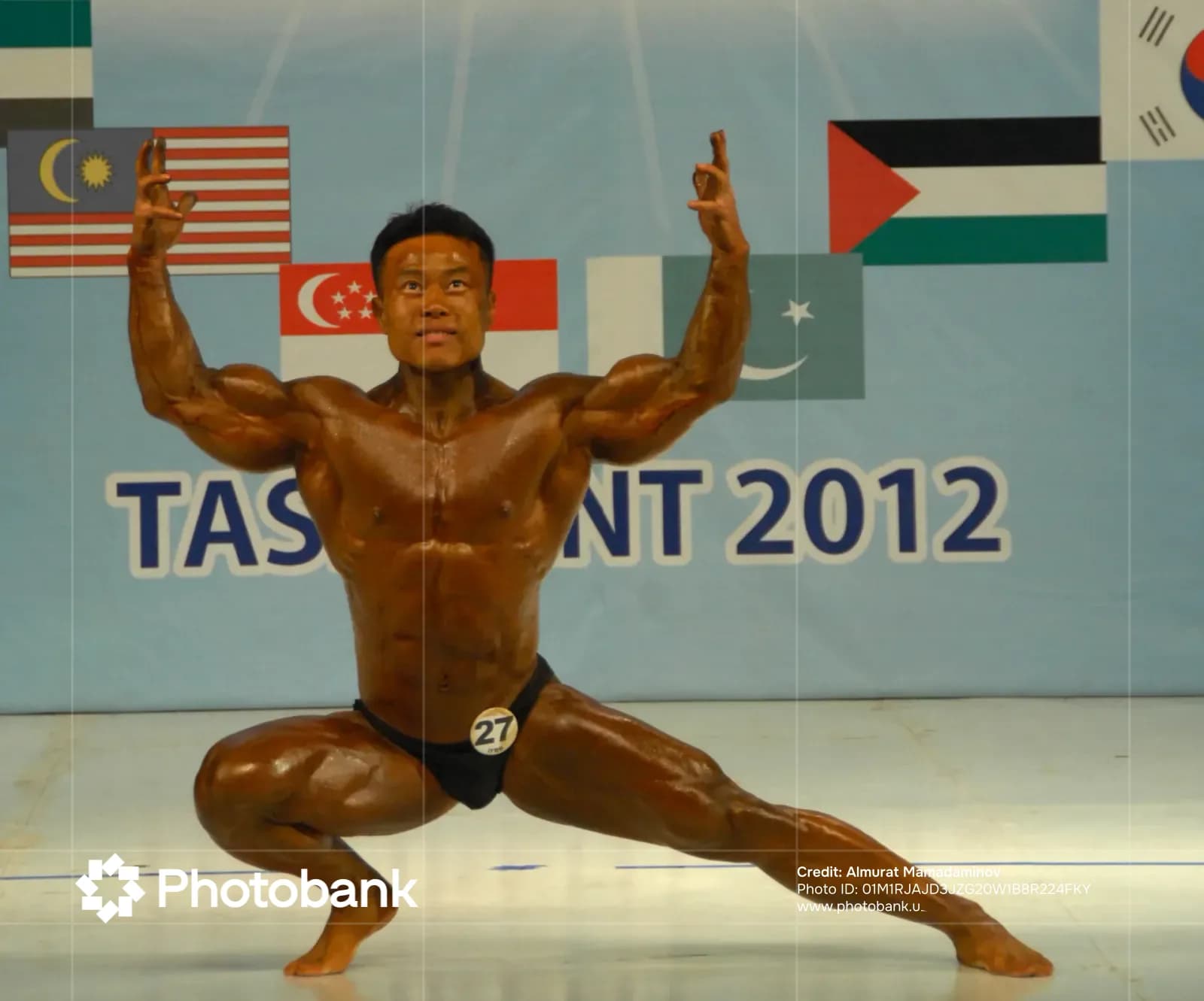 Athlete posing on stage during a bodybuilding competition