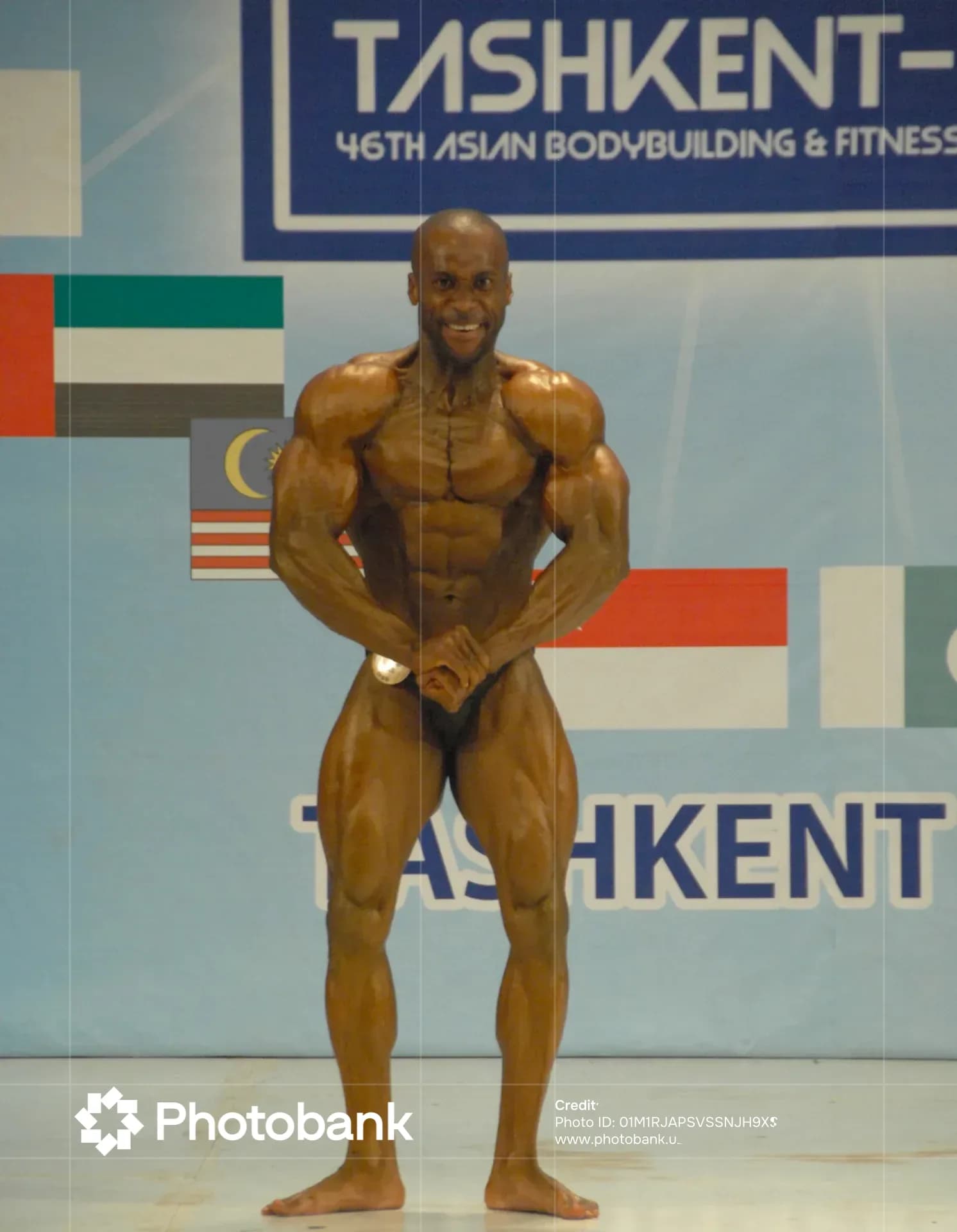 Athlete posing on stage during a bodybuilding competition