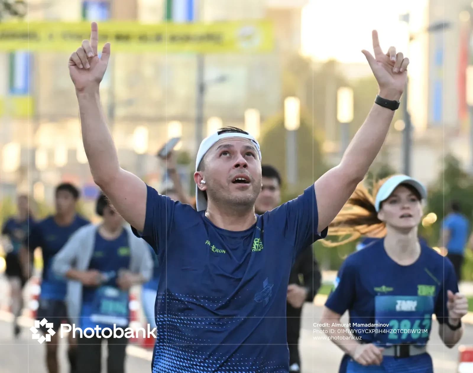 Participant celebrating during running event on city street