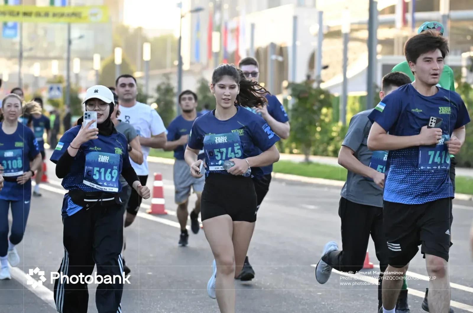 People running along a city street during a marathon
