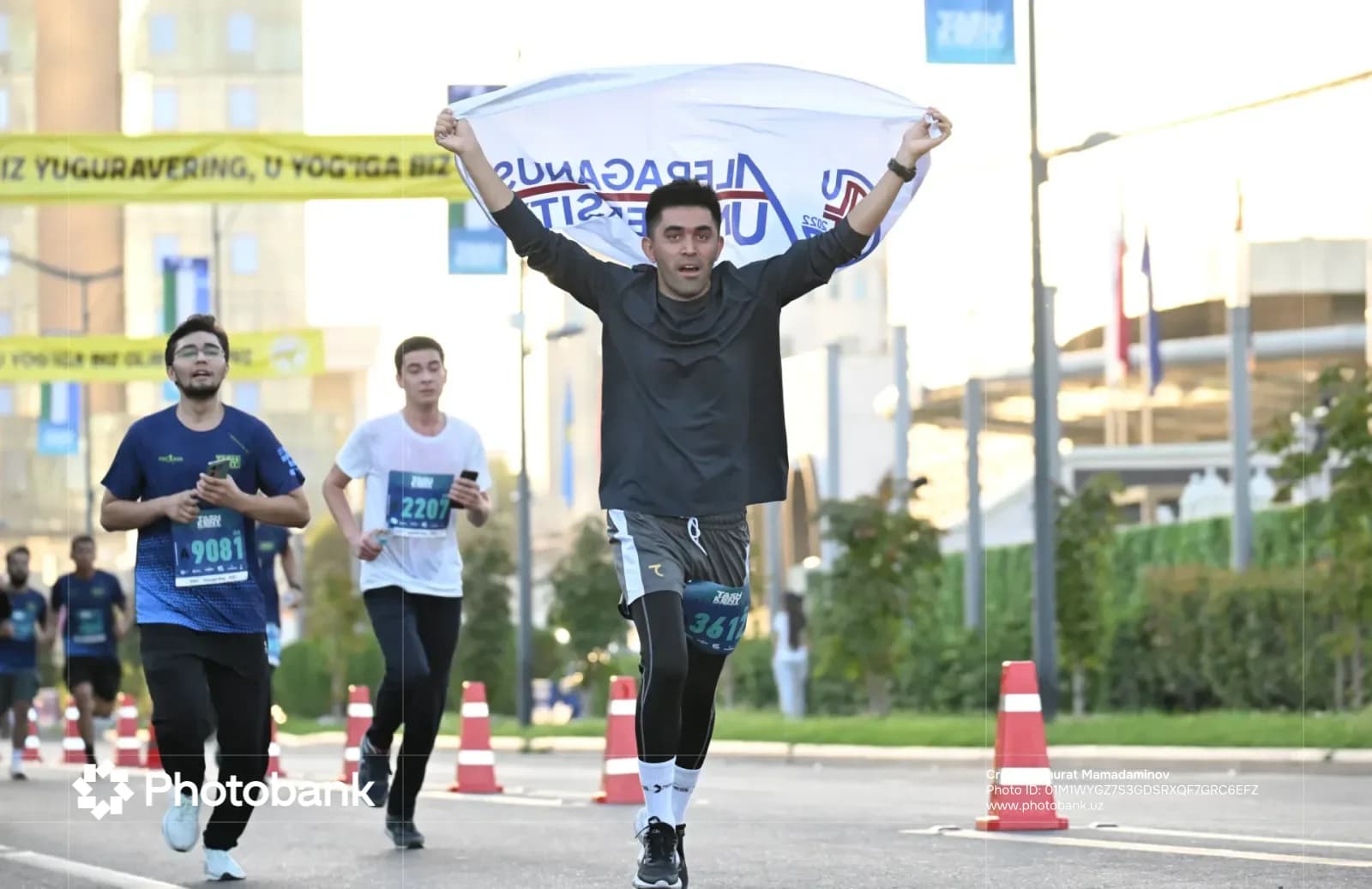 Participant holding a banner while running in a street race