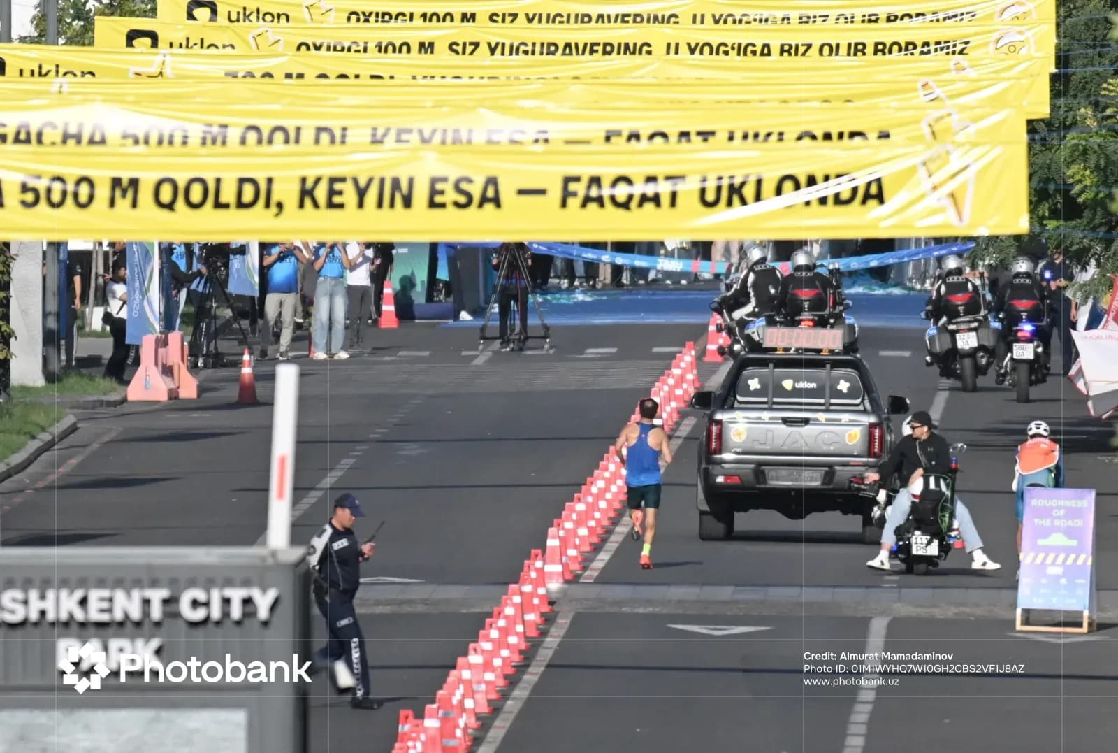 Athlete running along a city street during a competition