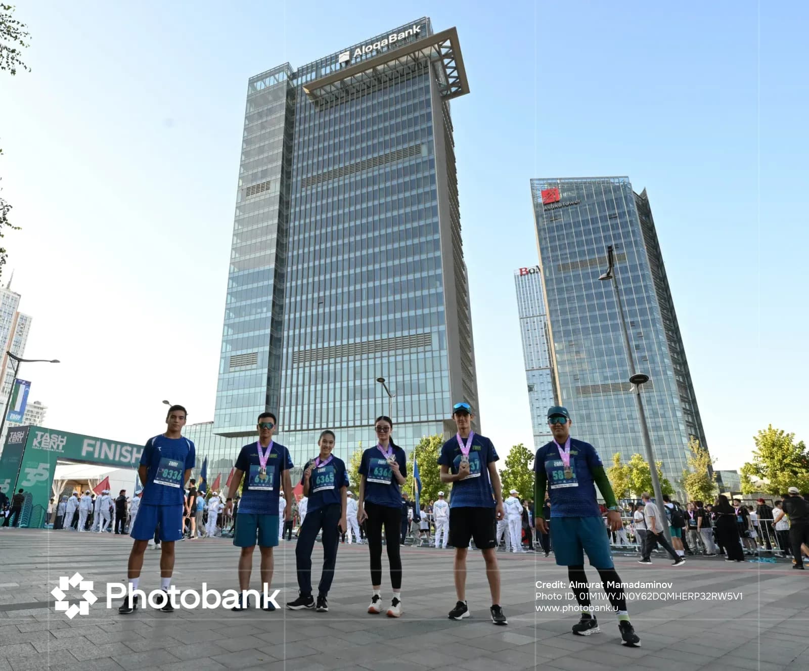 Participants posing in front of modern high-rise buildings