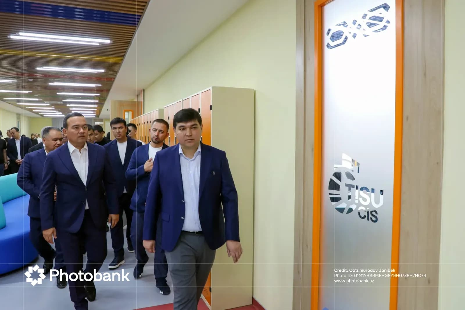 Group of men walking in a modern corridor
