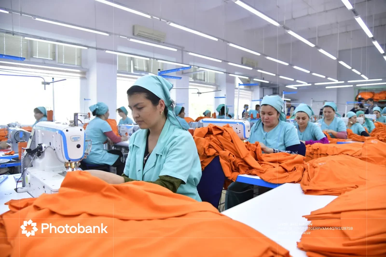 Workers sewing garments in a factory workshop