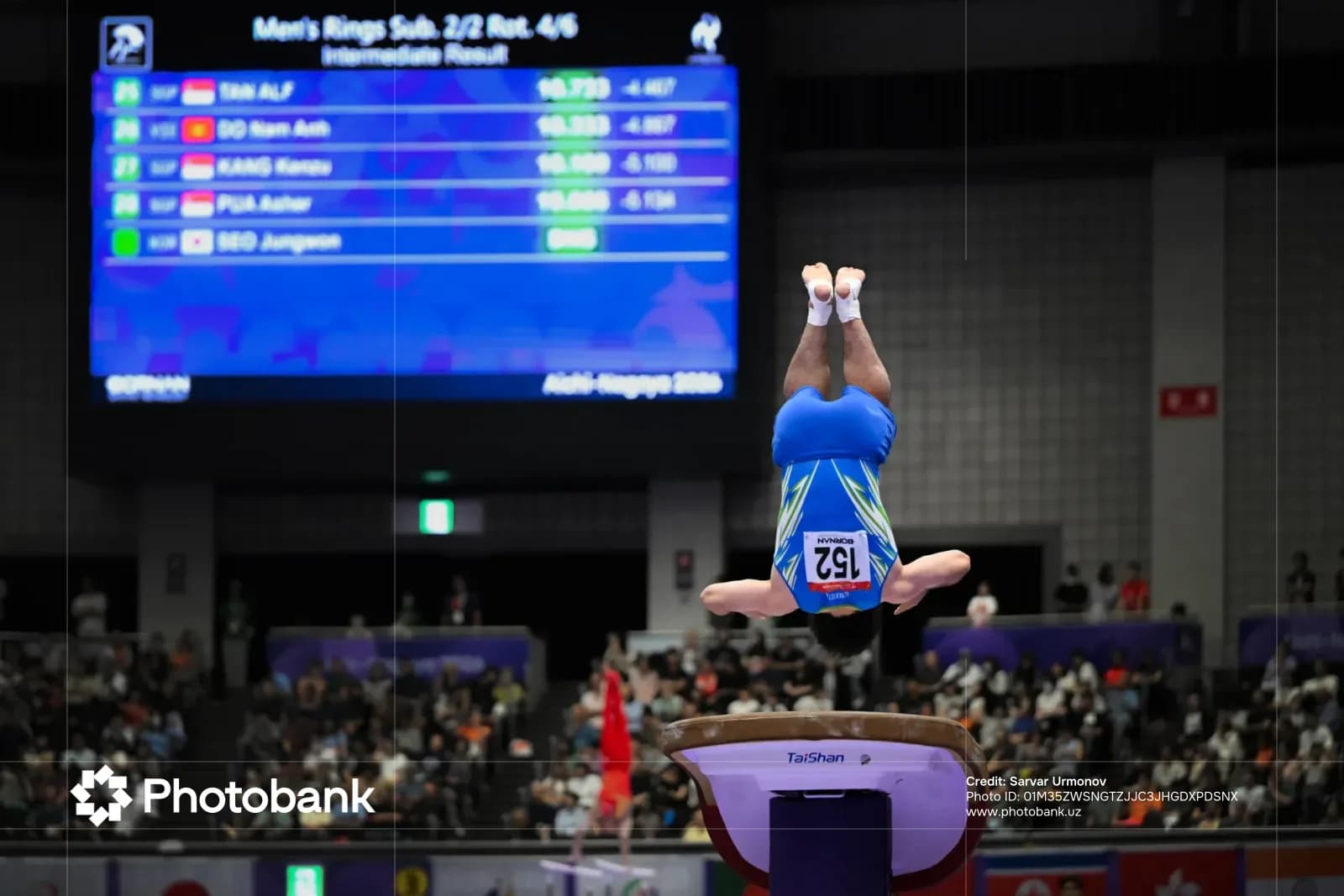 Athlete performing vaulting maneuver in sports competition arena