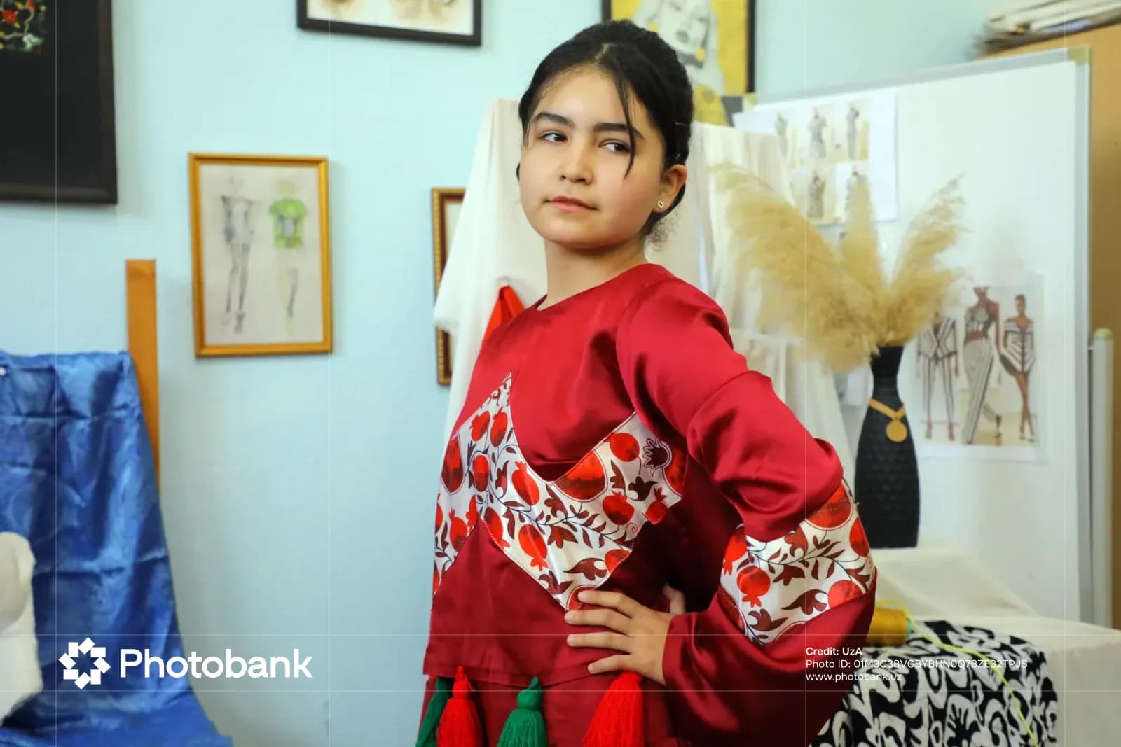 Young person in a red outfit posing in an interior setting