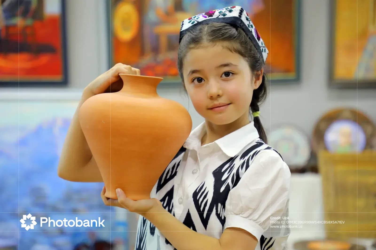 Young person holding a ceramic jug