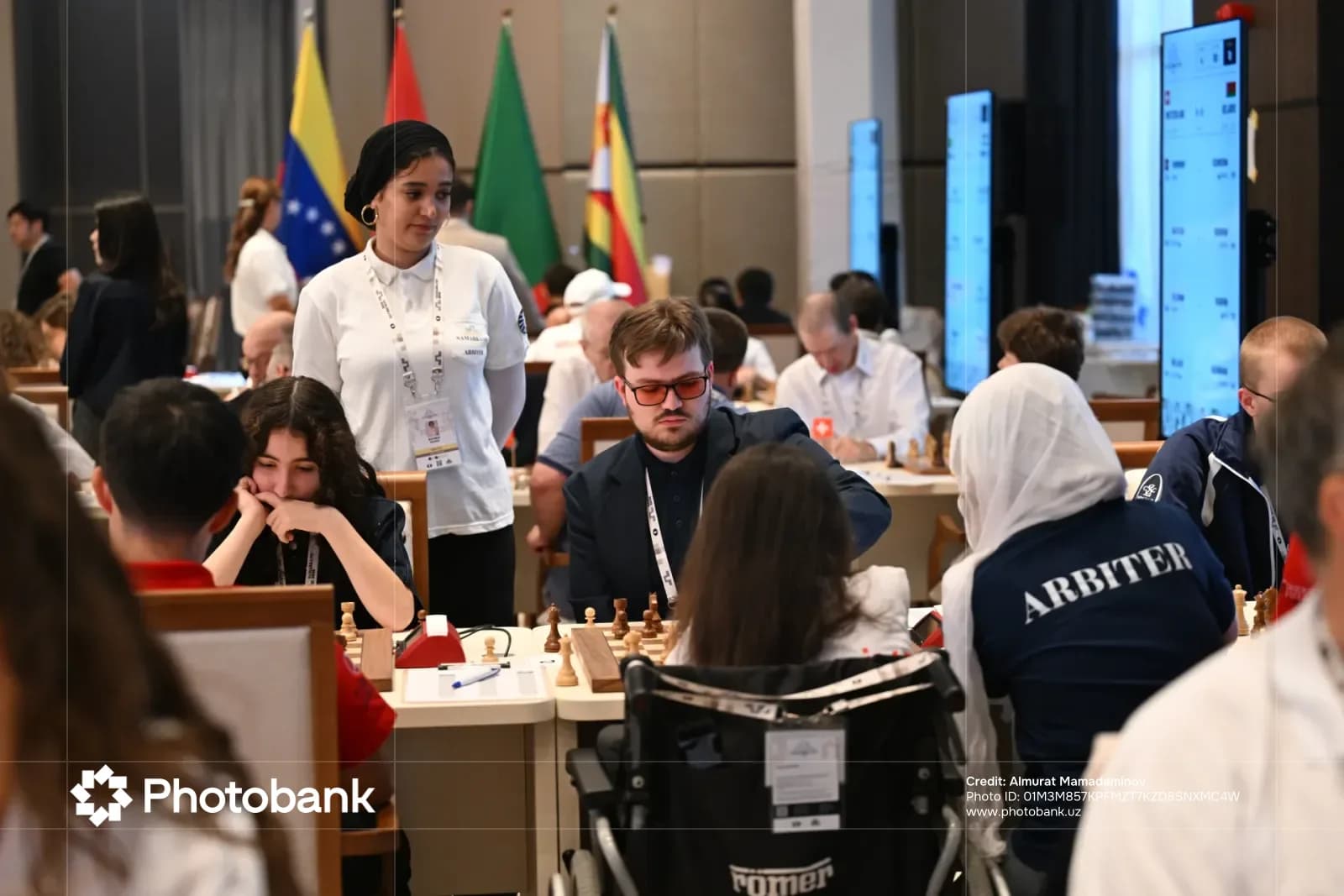 Competitors participate in an indoor chess tournament