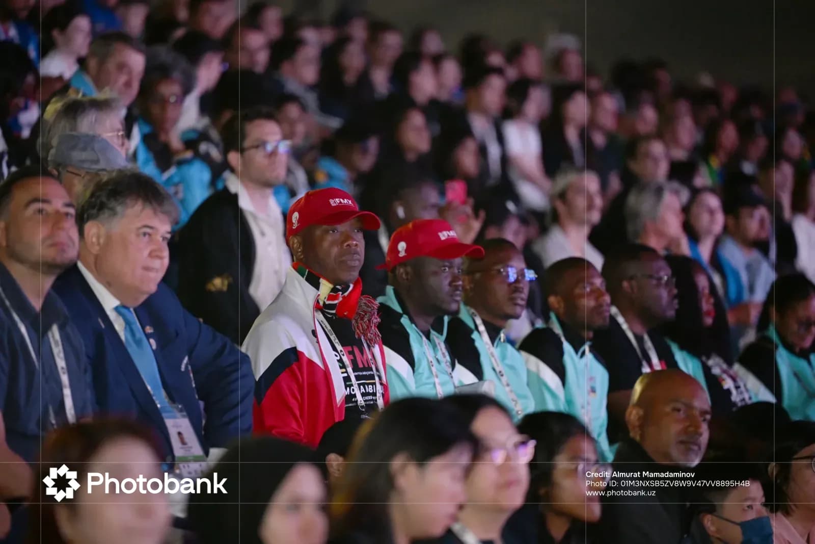 Spectators seated in a large audience