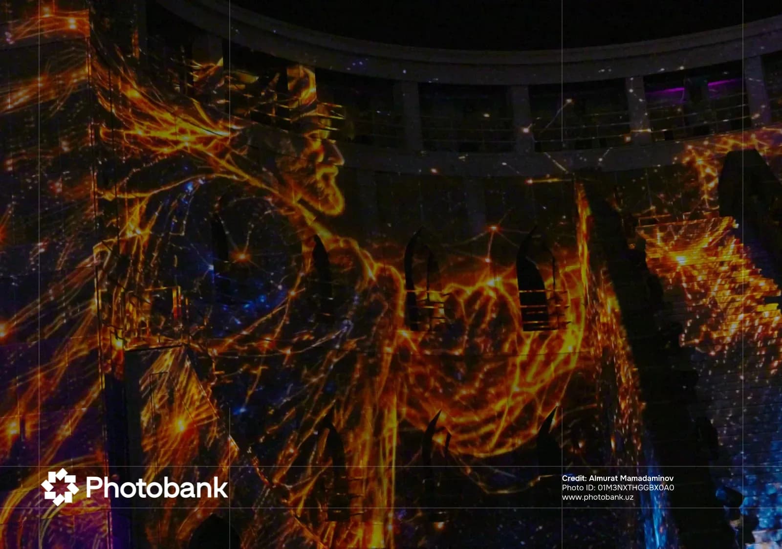 Projection mapping on a building facade showing a luminous figure
