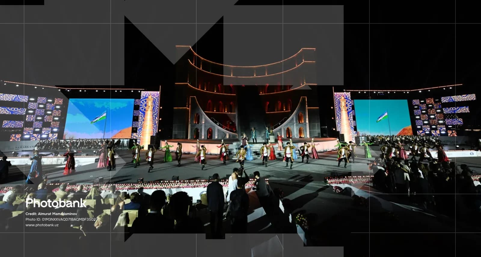Performers on stage during an outdoor evening cultural event