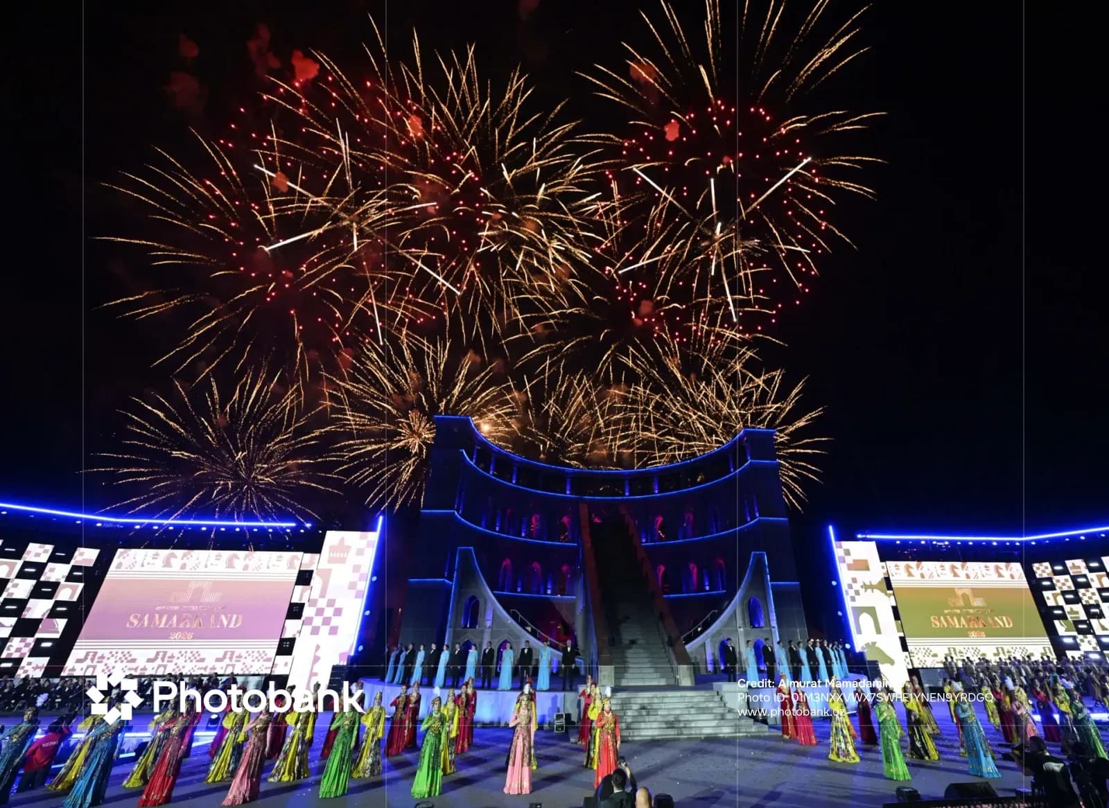 Fireworks illuminate a night celebration with performers on stage