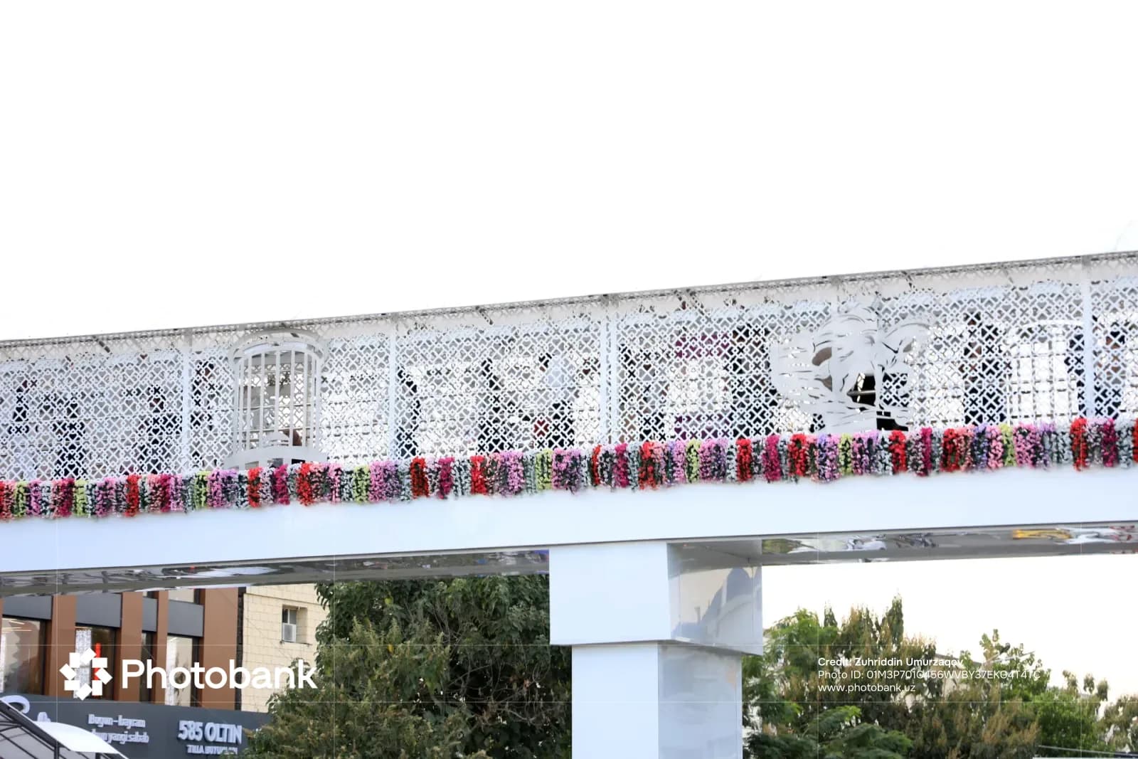 White pedestrian overpass decorated with floral arrangements