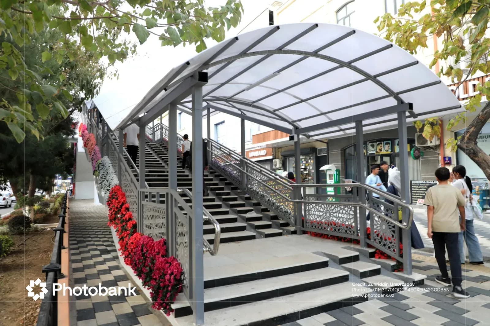 Pedestrian overpass with a covered staircase on a city street
