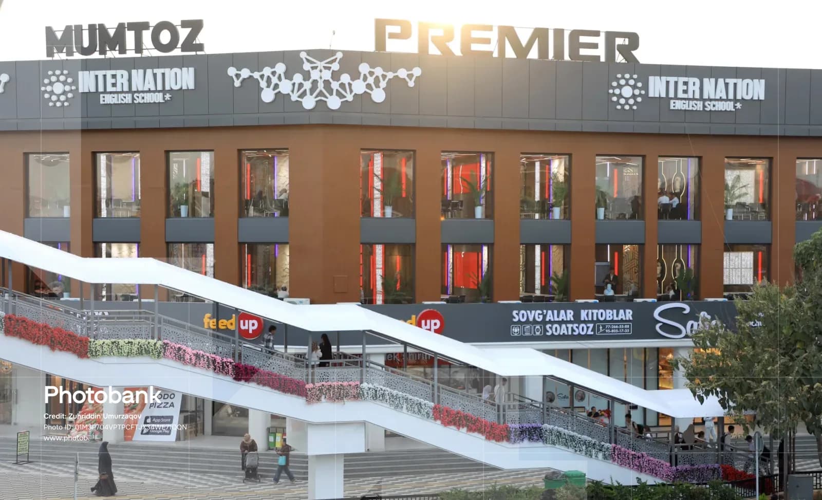 Modern commercial building exterior with pedestrian overpass