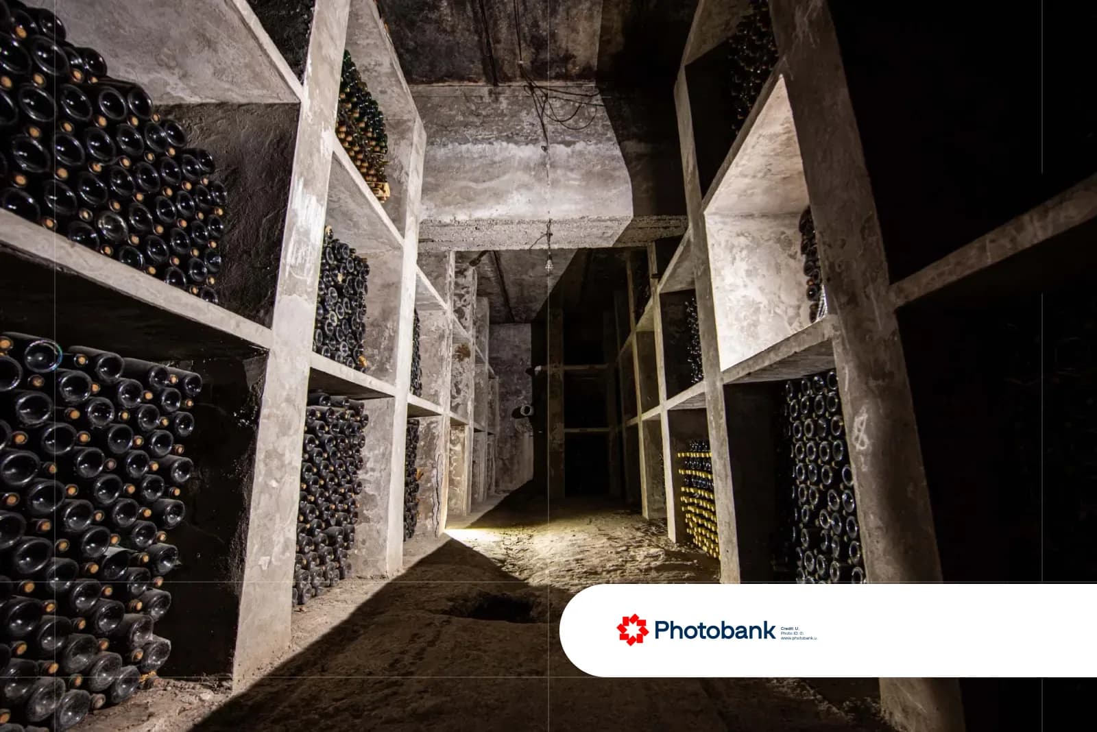 Concrete wine cellar with stacked bottles