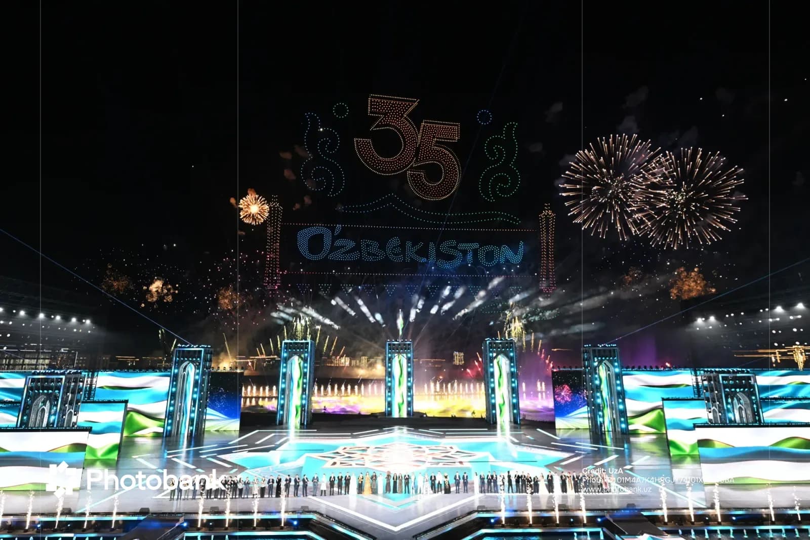 Festive light and drone show with fireworks over a stage