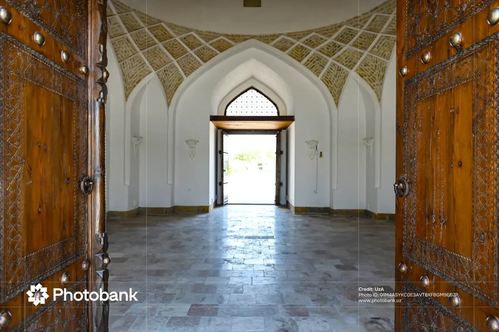Open wooden doors framing interior hall with vaulted ceiling