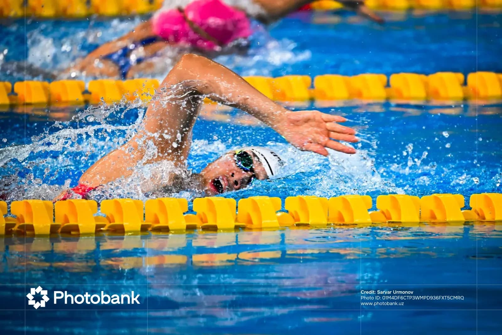 Swimmer competing in pool