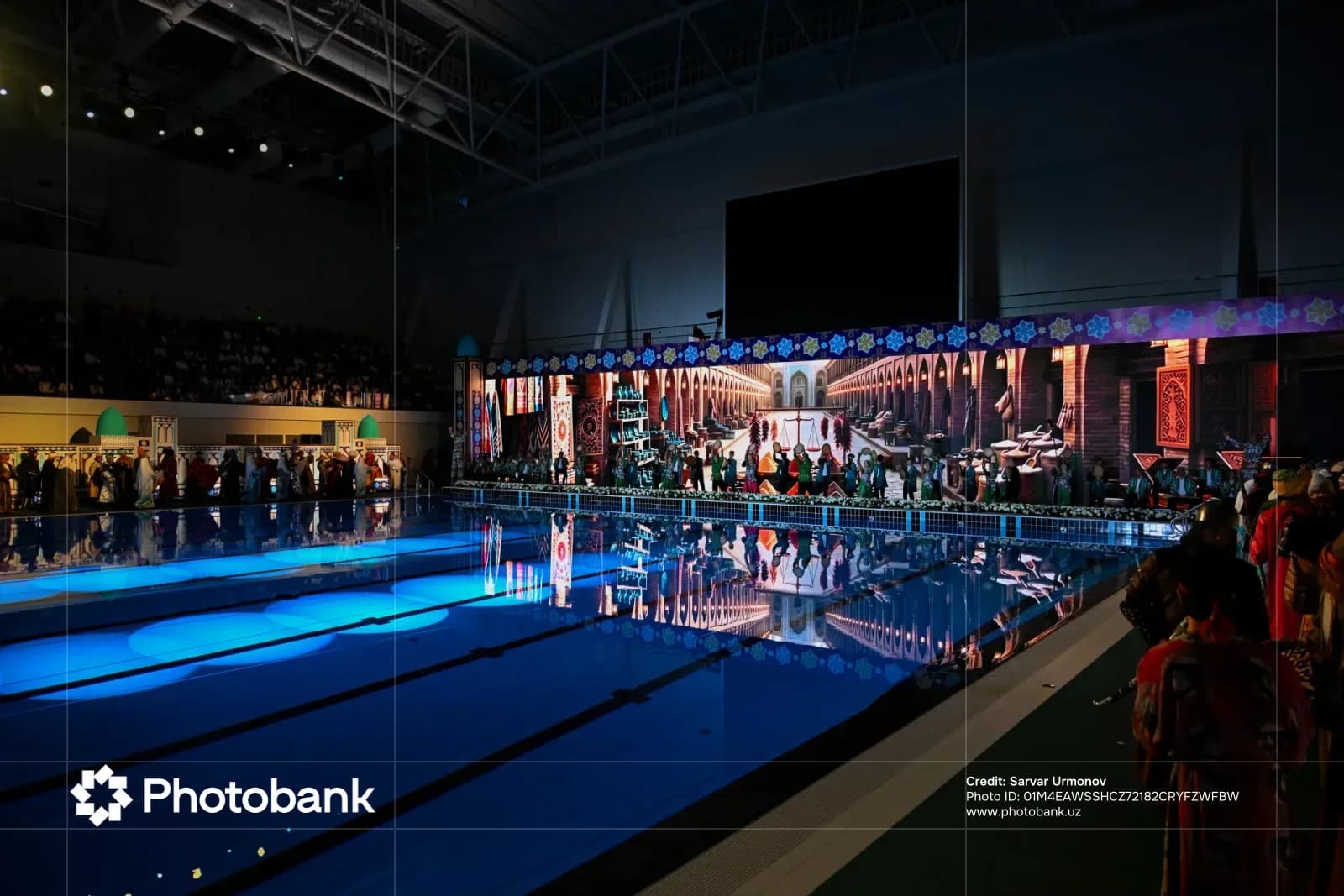 Cultural performance inside an indoor swimming pool venue