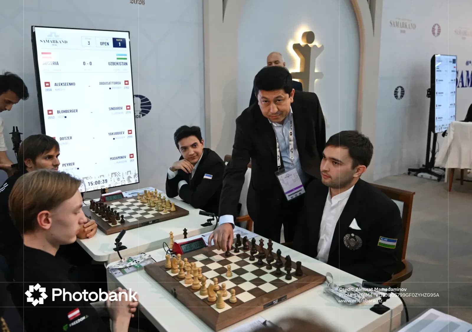 Players and referee at a chess competition table