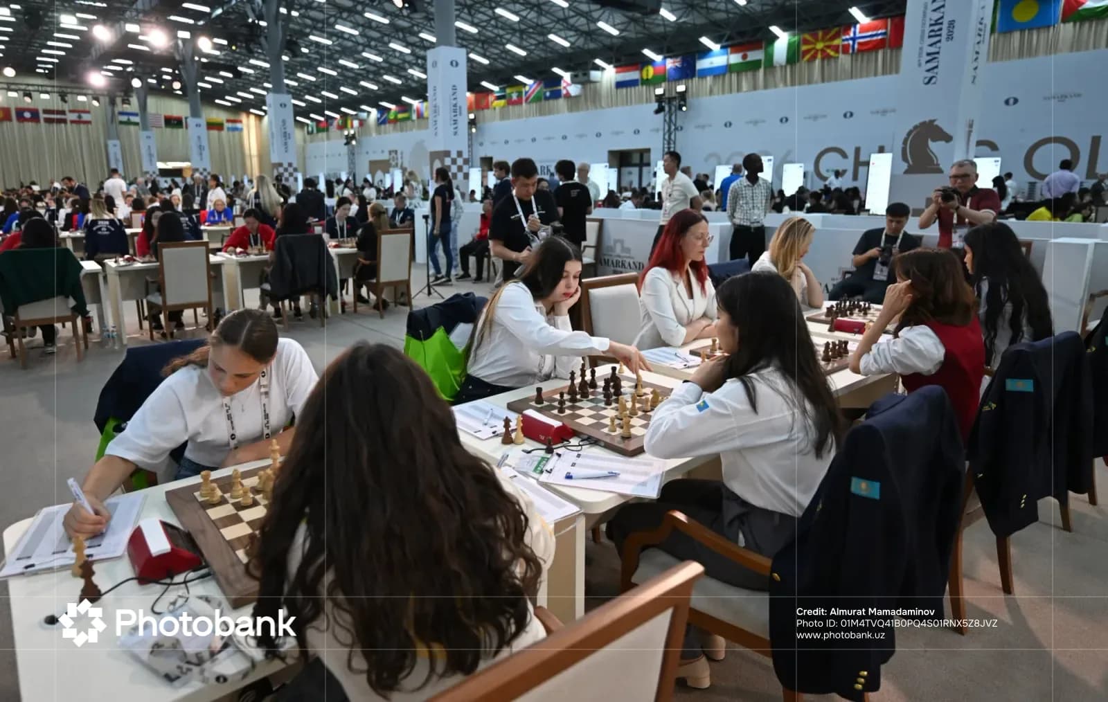 People playing chess in a tournament hall