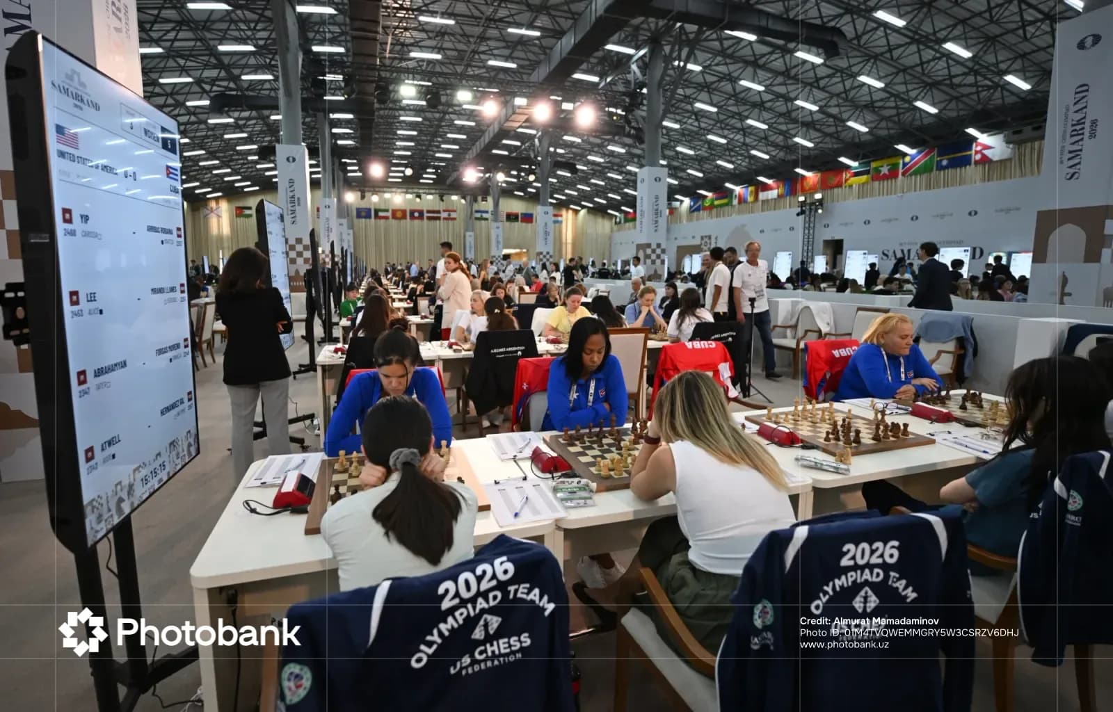 People playing chess at a competition in a large hall