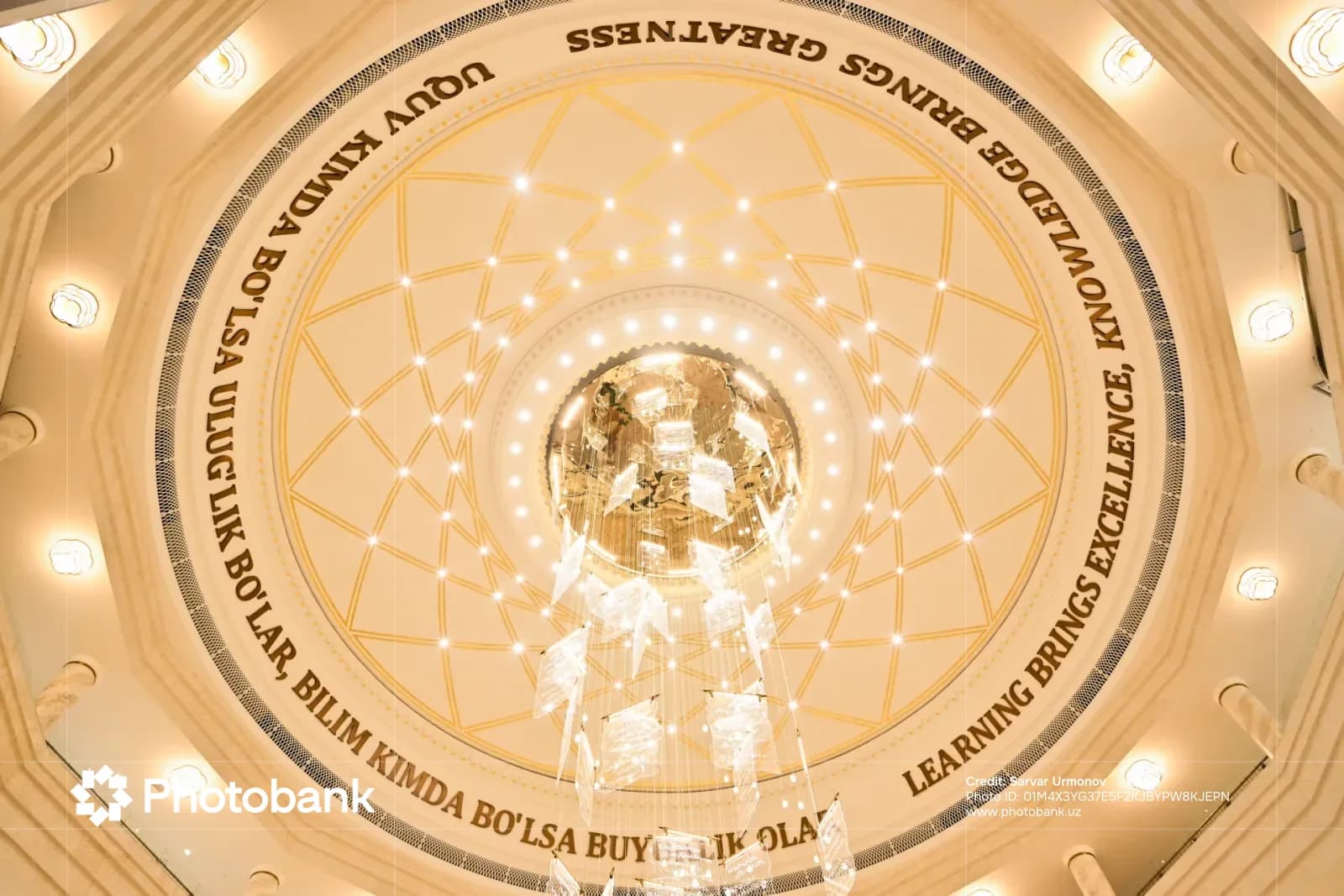 Interior dome ceiling with inscriptions and a hanging chandelier