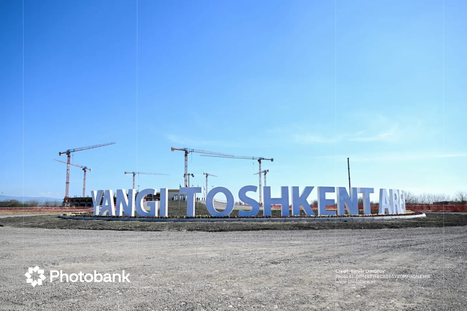Construction site with large lettering and cranes
