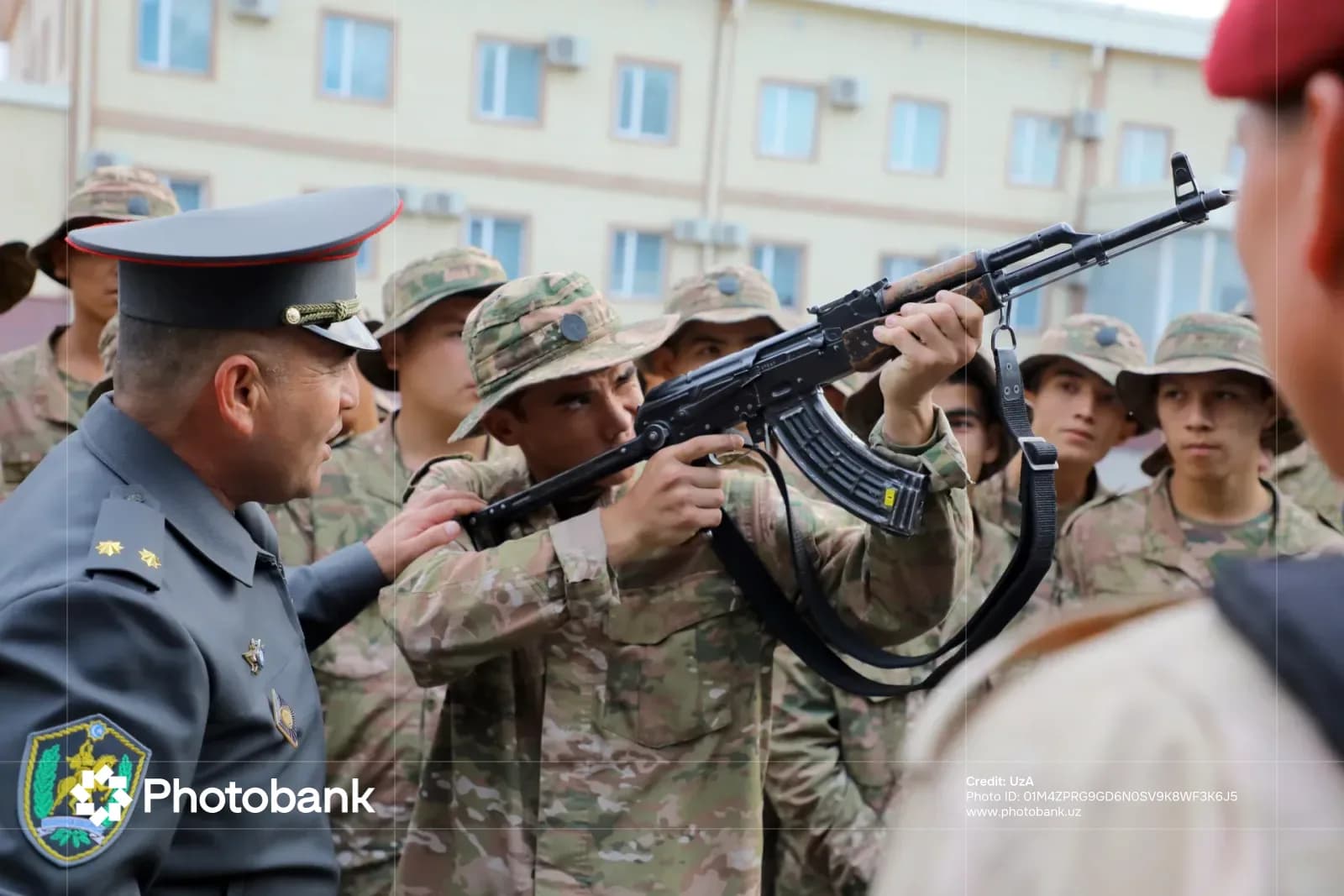 Военный инструктор, осуществляющий руководство солдатом с винтовкой во время тренировки