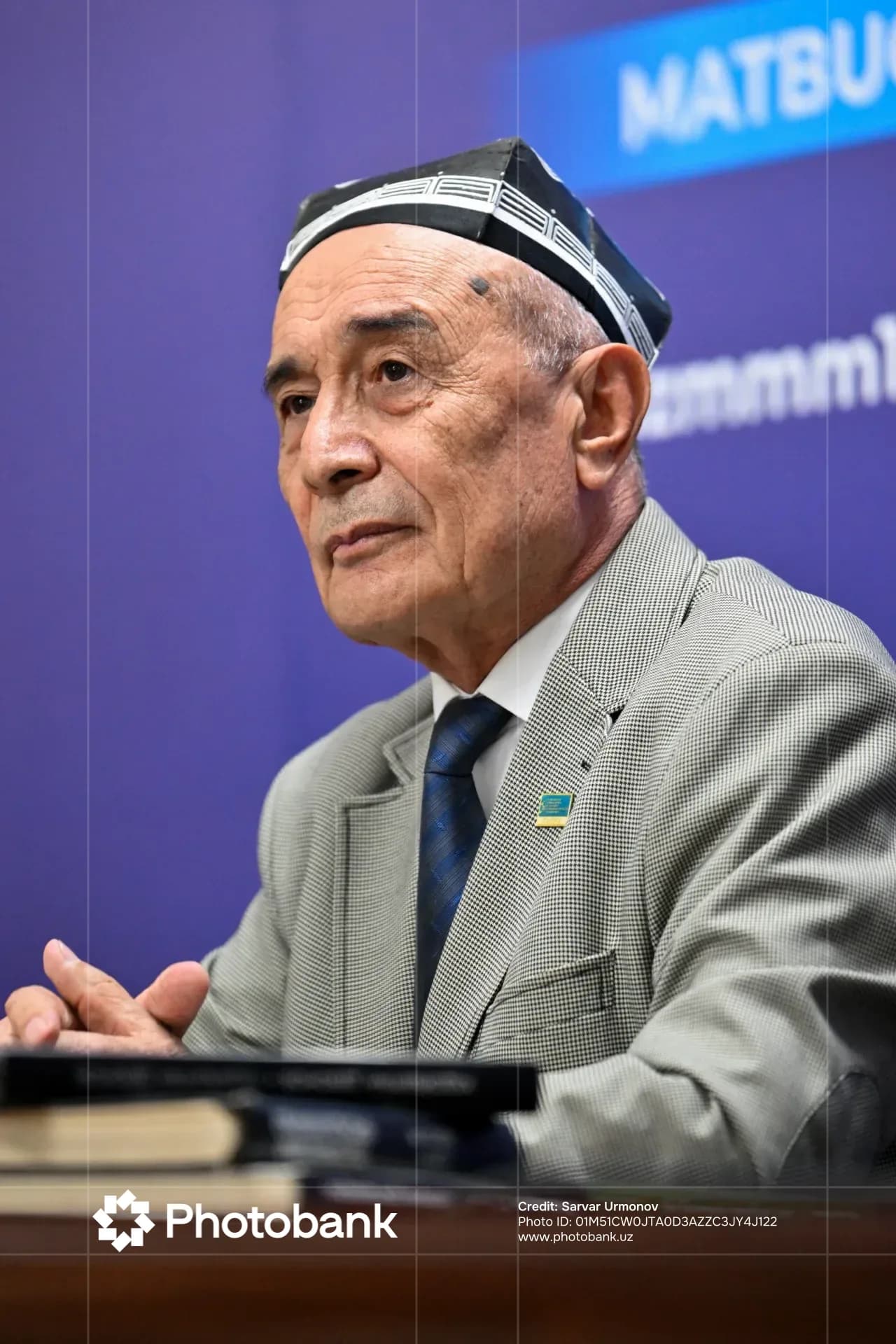 Portrait of an elderly man wearing traditional headwear