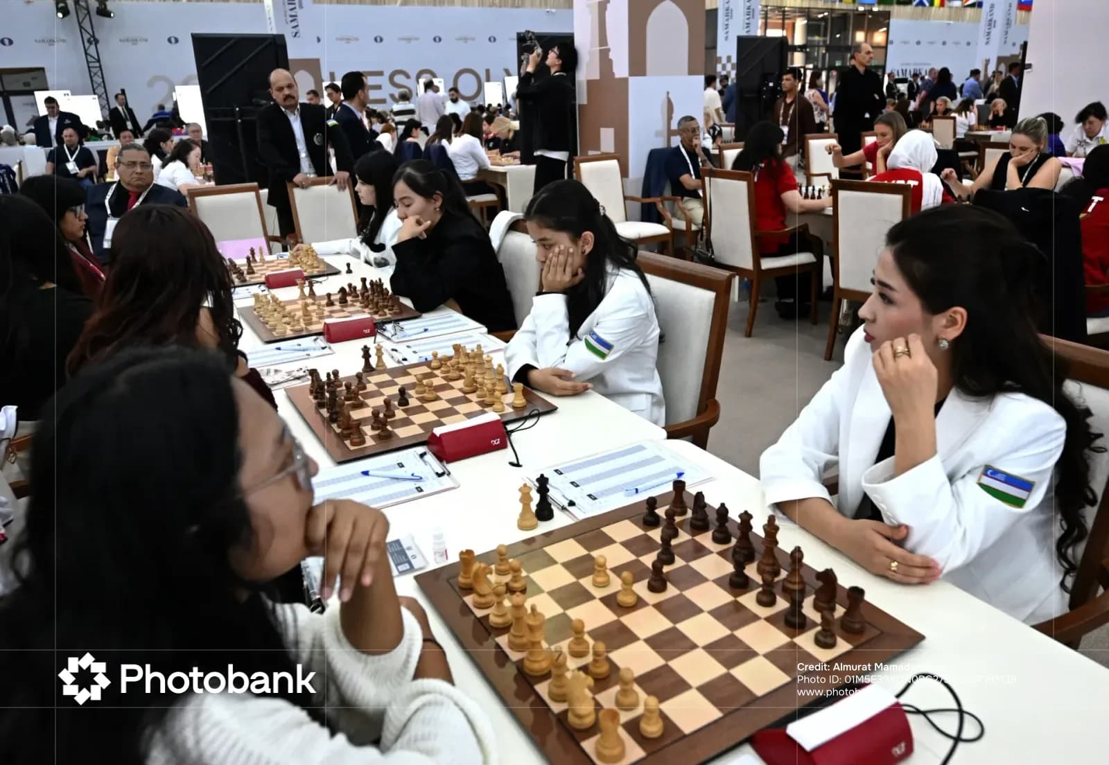 People participate in a chess competition in a large hall