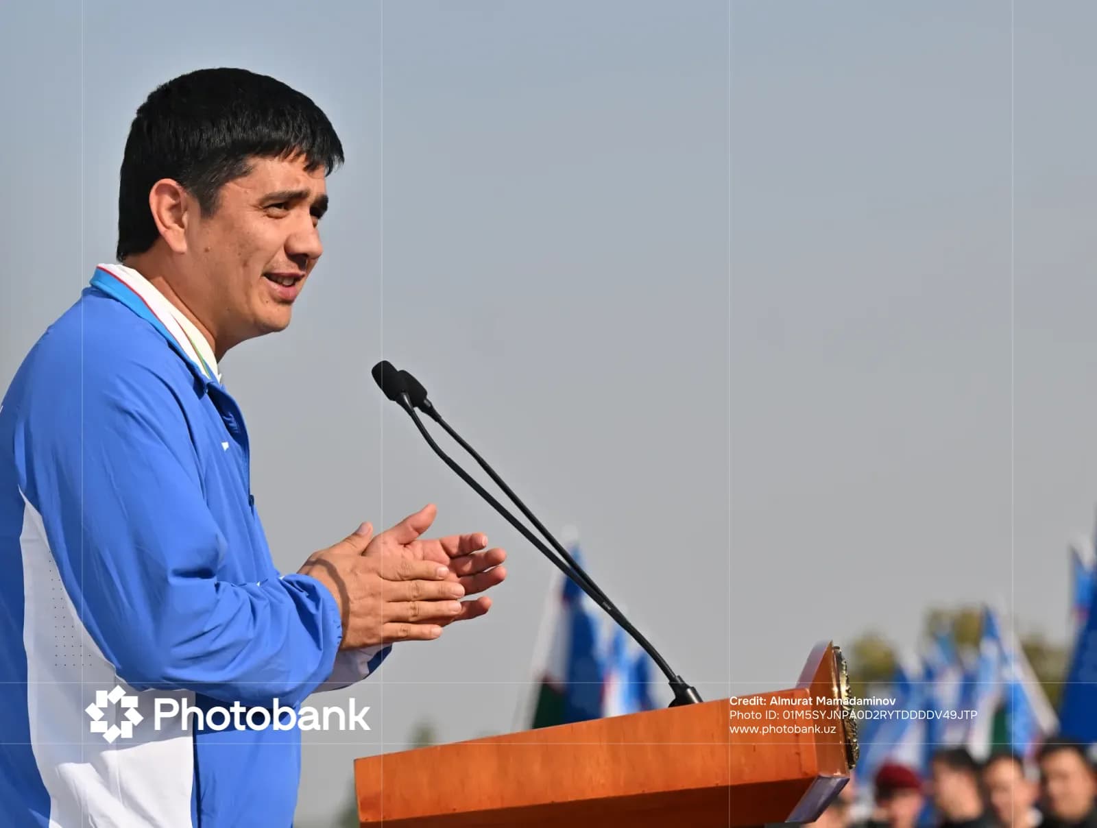 Person speaking at podium outdoors