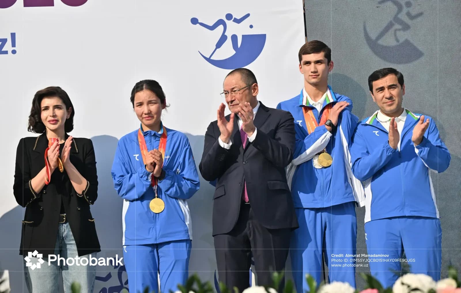 Adham Ikramov clapping among people