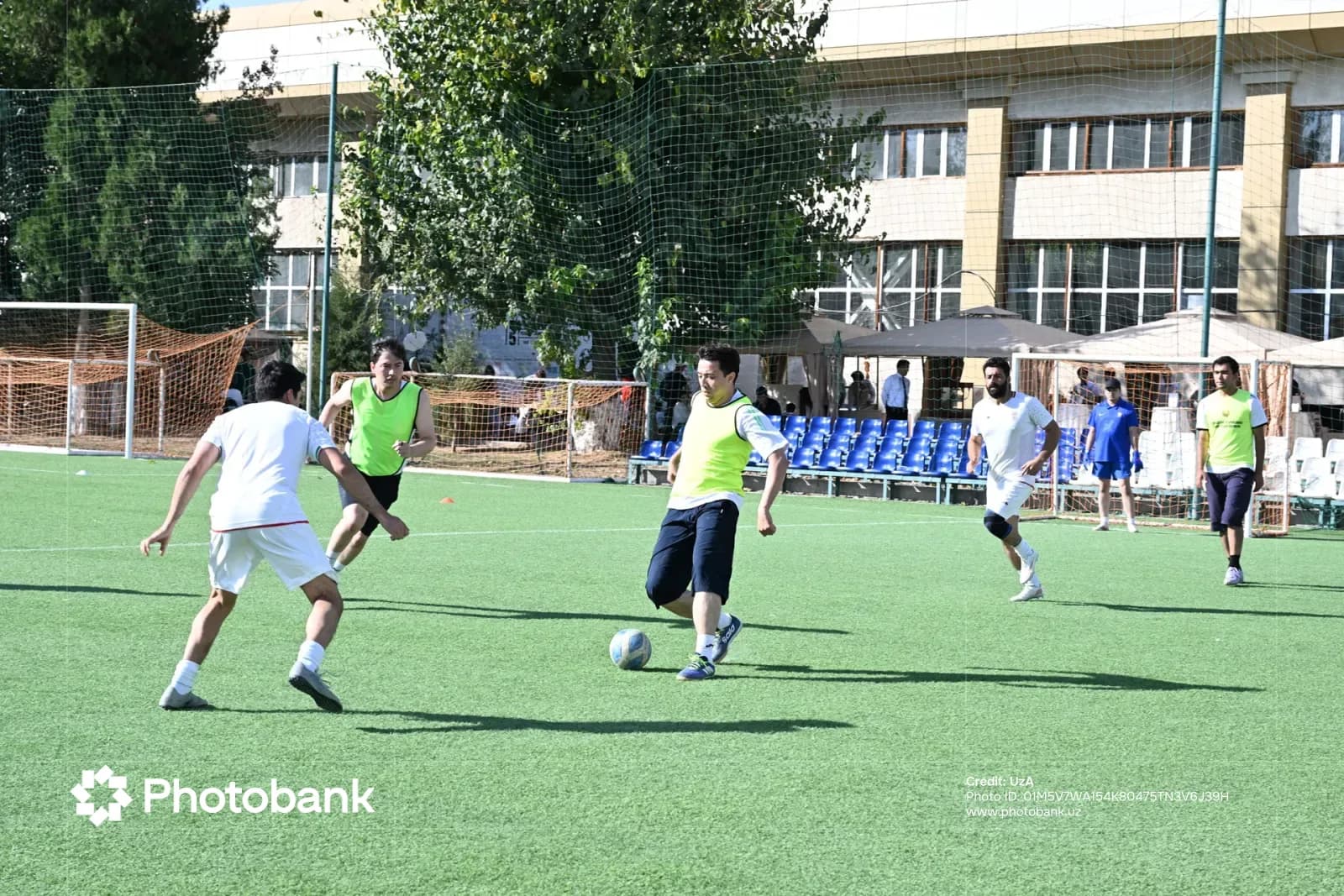 Men playing football on an outdoor artificial turf pitch