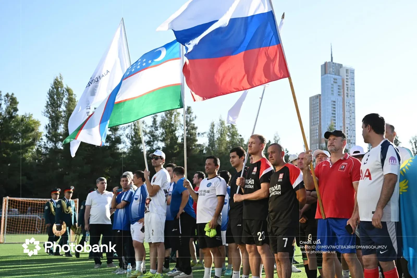 Люди с флагами на открытом воздухе на спортивном поле