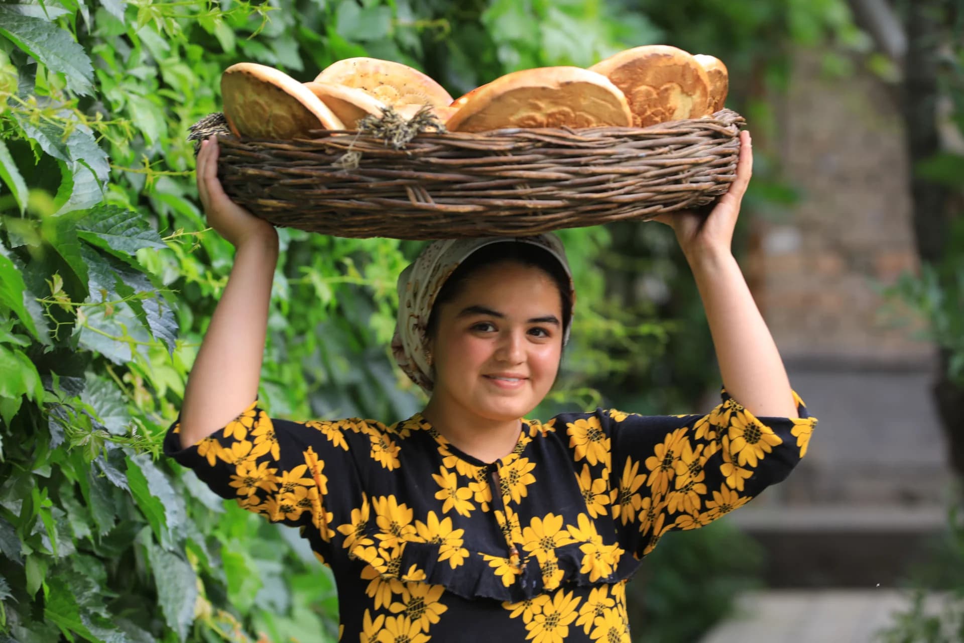 Young woman carrying bread basket